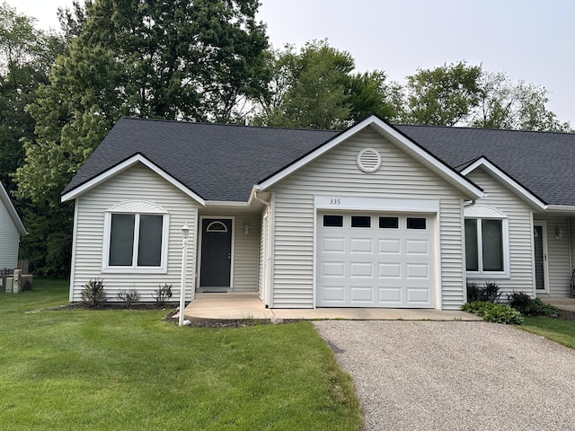 335 Nestlewood Dr, Holland, MI 49424 - single story home featuring an attached garage, a shingled roof, asphalt driveway, and a front yard
