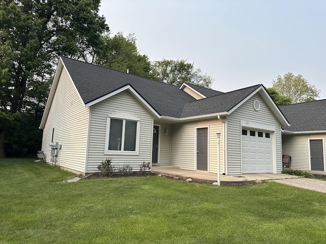 335 Nestlewood Dr, Holland, MI 49424 - ranch-style house featuring a garage, roof with shingles, concrete driveway, and a front lawn