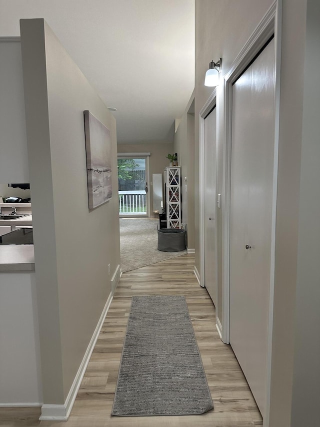 335 Nestlewood Dr, Holland, MI 49424 - corridor featuring light wood-type flooring and baseboards