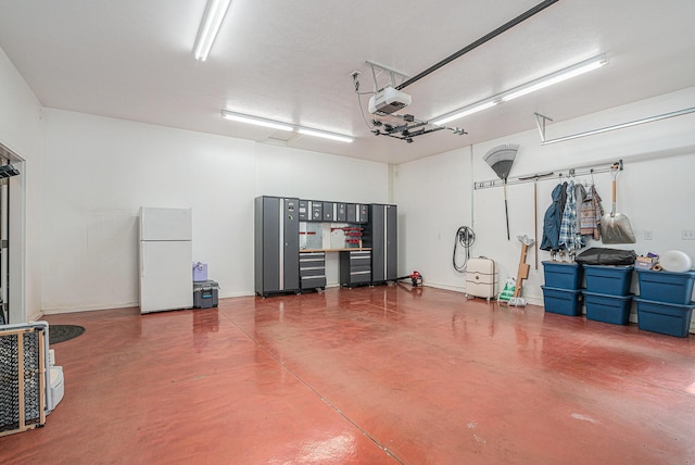 23772 Wilson Rd, Sturgis, MI 49091 - garage featuring freestanding refrigerator and a garage door opener