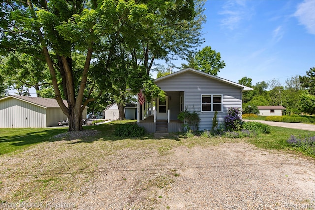 6593 Sherman Dr, Otter Lake, MI 48464 - view of front of house with covered porch and a front yard