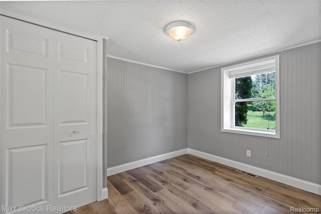 6593 Sherman Dr, Otter Lake, MI 48464 - unfurnished bedroom featuring wood finished floors, baseboards, a closet, and ornamental molding