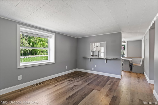 6593 Sherman Dr, Otter Lake, MI 48464 - unfurnished living room with dark wood finished floors and baseboards