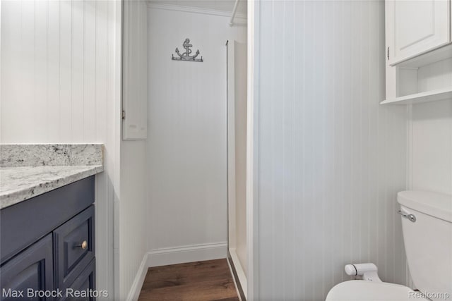 6593 Sherman Dr, Otter Lake, MI 48464 - bathroom featuring toilet, wood finished floors, vanity, and baseboards