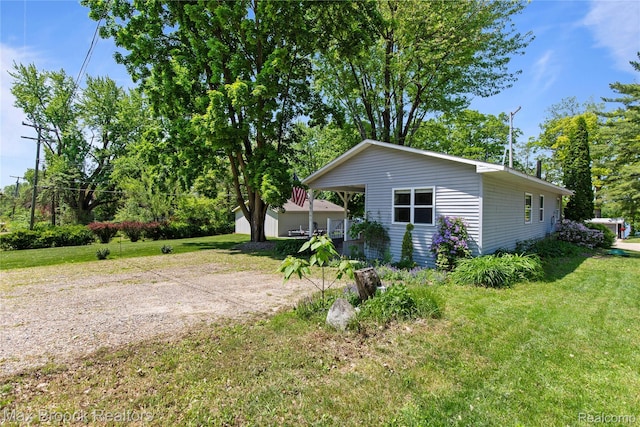 6593 Sherman Dr, Otter Lake, MI 48464 - view of side of property featuring a lawn
