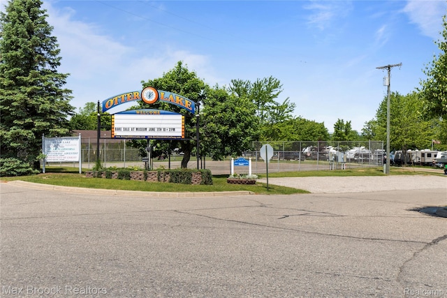 6593 Sherman Dr, Otter Lake, MI 48464 - view of asphalt road featuring traffic signs