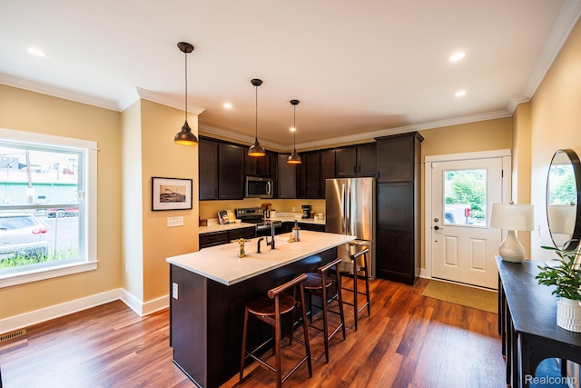 215 W Fifth Ave Unit 2, Flint, MI 48502 - kitchen featuring stainless steel appliances, dark brown cabinetry, dark wood-type flooring, a breakfast bar area, and ornamental molding