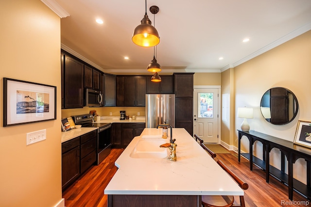 215 W Fifth Ave Unit 2, Flint, MI 48502 - kitchen with stainless steel appliances, dark brown cabinetry, light countertops, crown molding, and an island with sink