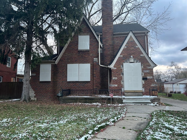 18815 Lancashire St, Detroit, MI 48223 - english style home featuring brick siding, a chimney, and a shingled roof