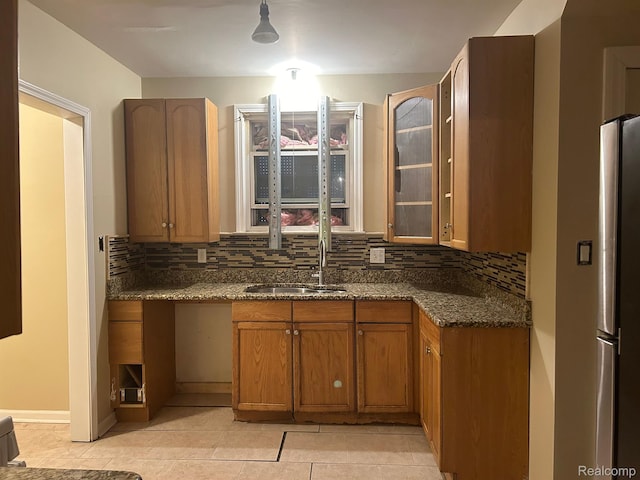 18815 Lancashire St, Detroit, MI 48223 - kitchen with a sink, decorative backsplash, brown cabinetry, and light tile patterned flooring