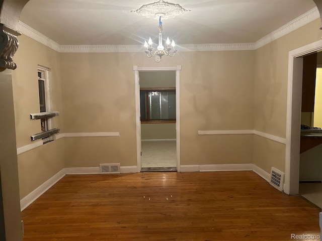 18815 Lancashire St, Detroit, MI 48223 - unfurnished dining area with a chandelier, wood finished floors, ornamental molding, and baseboards