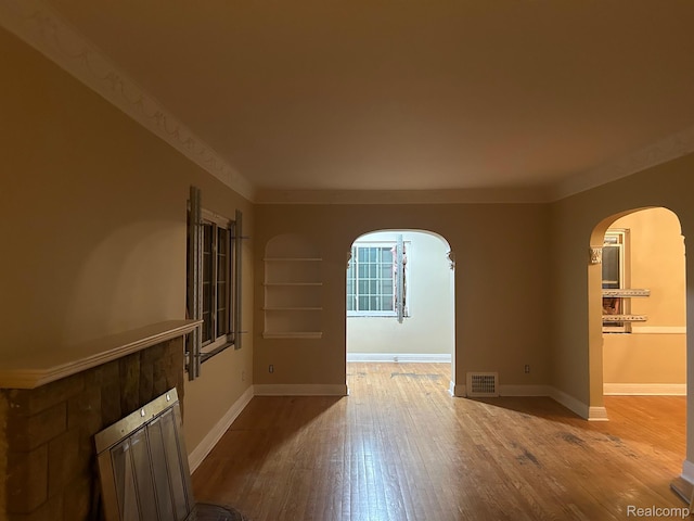 18815 Lancashire St, Detroit, MI 48223 - unfurnished room featuring arched walkways, wood finished floors, baseboards, and crown molding