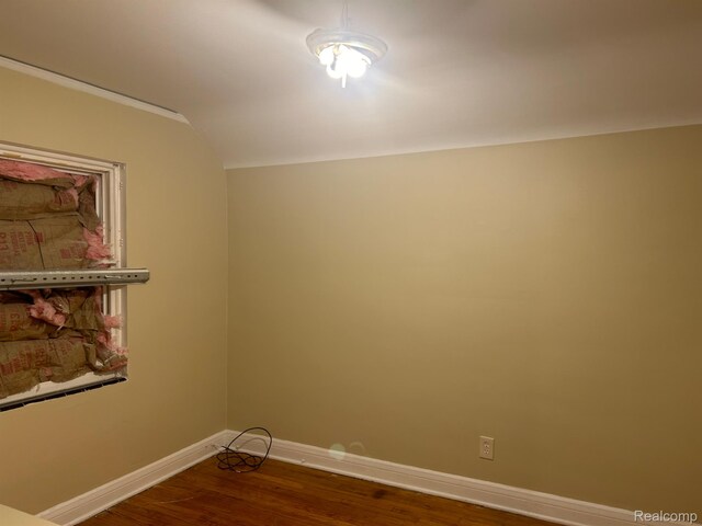 18815 Lancashire St, Detroit, MI 48223 - empty room featuring dark wood finished floors, baseboards, and vaulted ceiling