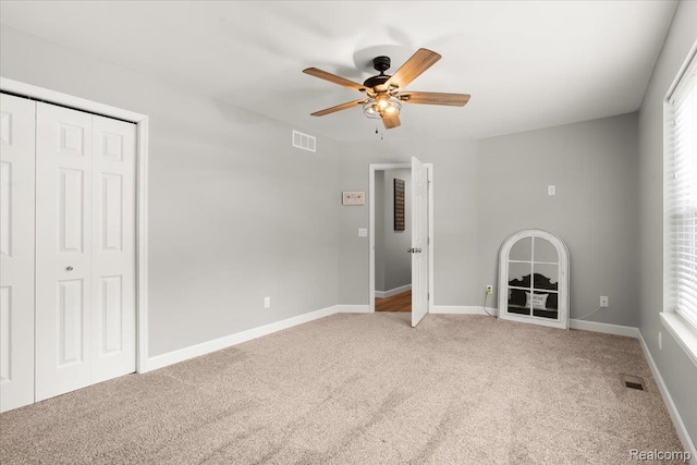 2230 Briar Rdg, Wolverine Lake, MI 48390 - unfurnished bedroom featuring light colored carpet, a closet, baseboards, and a ceiling fan