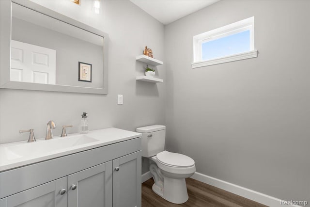 2230 Briar Rdg, Wolverine Lake, MI 48390 - half bathroom featuring wood finished floors, baseboards, toilet, and vanity