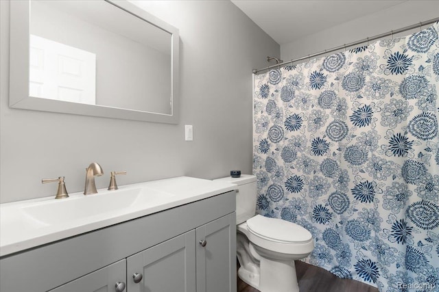 2230 Briar Rdg, Wolverine Lake, MI 48390 - full bathroom with vanity, toilet, curtained shower, and wood finished floors