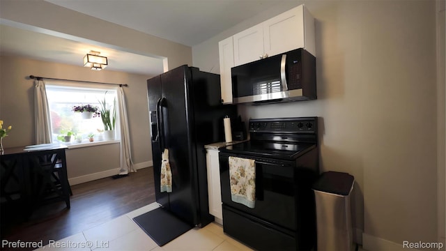 8483 Harding, Center Line, MI 48015 - kitchen with black appliances, white cabinets, baseboards, and light wood-style flooring