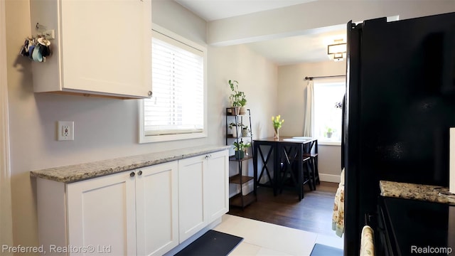 8483 Harding, Center Line, MI 48015 - kitchen featuring healthy amount of natural light, white cabinetry, and freestanding refrigerator