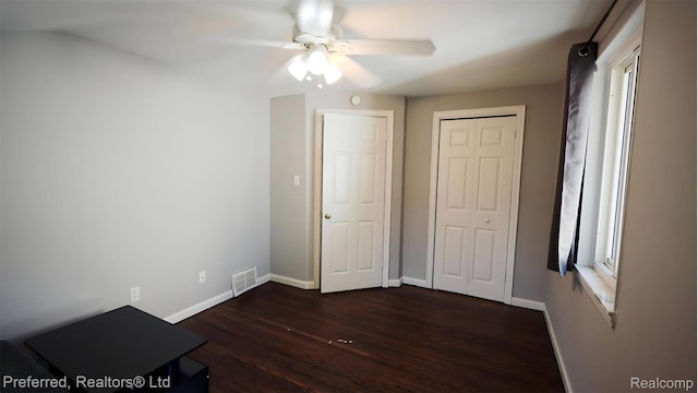 8483 Harding, Center Line, MI 48015 - unfurnished bedroom featuring dark wood finished floors, baseboards, a closet, and a ceiling fan