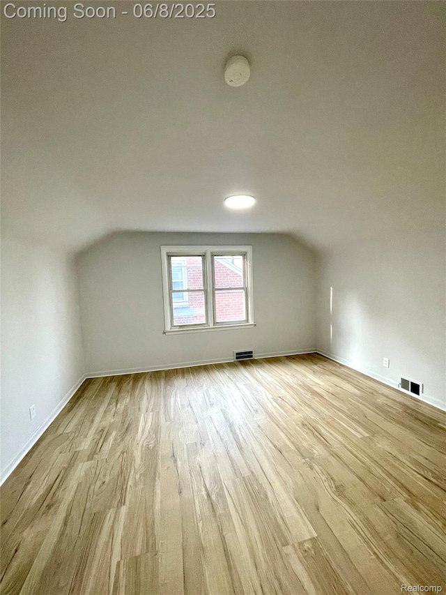 1311 12th St, Wyandotte, MI 48192 - bonus room with lofted ceiling, wood finished floors, and baseboards
