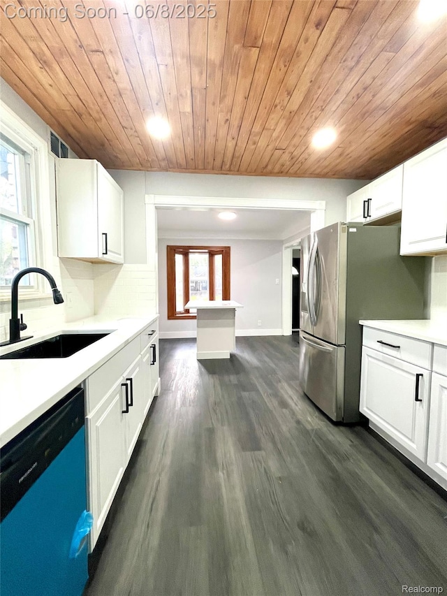 1311 12th St, Wyandotte, MI 48192 - kitchen featuring dishwashing machine, wood ceiling, a sink, white cabinetry, and light countertops
