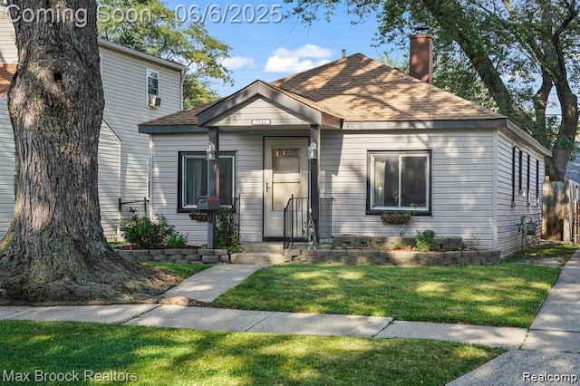 7713 Jackson St, Taylor, MI 48180 - view of front of home featuring a chimney, a front lawn, and a shingled roof