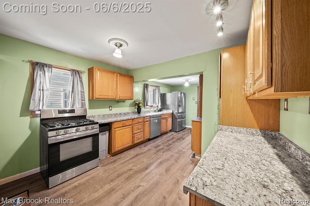 7713 Jackson St, Taylor, MI 48180 - kitchen with stainless steel appliances, light wood-style floors, baseboards, and a sink