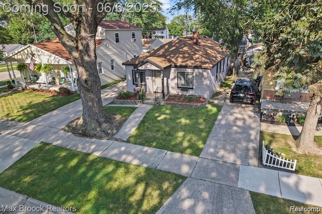 7713 Jackson St, Taylor, MI 48180 - view of front facade featuring a front lawn, concrete driveway, and a porch