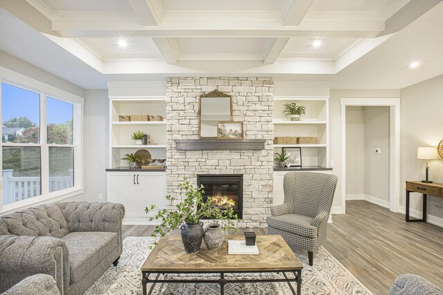 2748 Woodhaven Ct SW Unit 03, Byron Center, MI 49315 - living area featuring baseboards, wood finished floors, a stone fireplace, beamed ceiling, and coffered ceiling