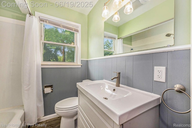 36551 Parkdale St, Livonia, MI 48150 - bathroom featuring vanity, a wainscoted wall, shower / bath combination with curtain, and wood finished floors