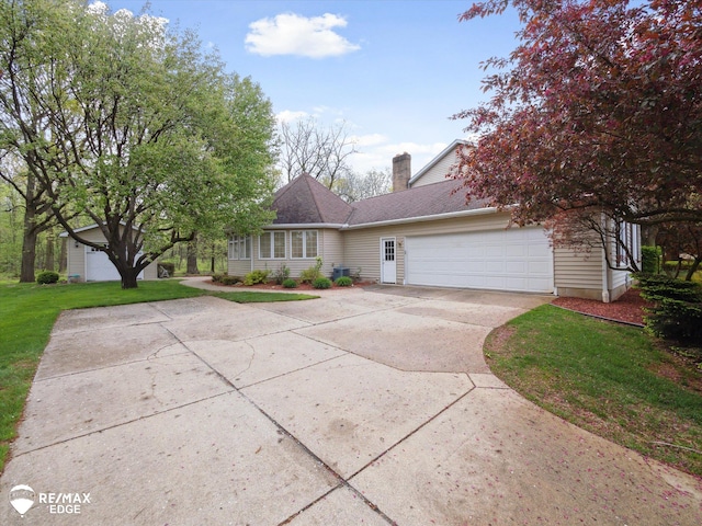 9705 Burning Tree Dr, Grand Blanc, MI 48439 - view of front facade with concrete driveway, a garage, a front lawn, a chimney, and roof with shingles