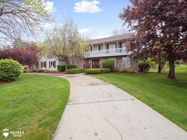 9705 Burning Tree Dr, Grand Blanc, MI 48439 - view of property featuring a balcony, a front yard, driveway, and brick siding