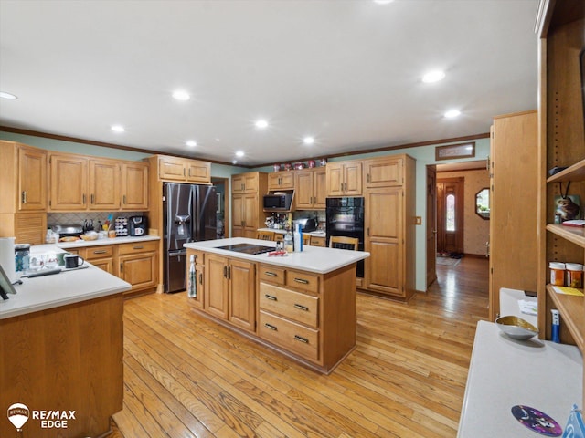 9705 Burning Tree Dr, Grand Blanc, MI 48439 - kitchen with black appliances, decorative backsplash, light wood-style flooring, light countertops, and recessed lighting