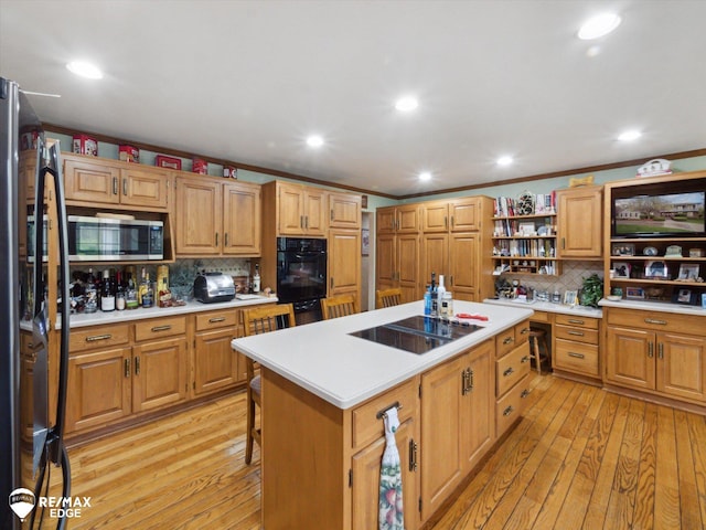 9705 Burning Tree Dr, Grand Blanc, MI 48439 - kitchen featuring black appliances, backsplash, a kitchen island, light countertops, and open shelves