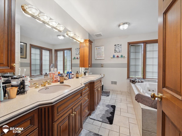 9705 Burning Tree Dr, Grand Blanc, MI 48439 - full bath featuring double vanity, a jetted tub, and tile patterned flooring