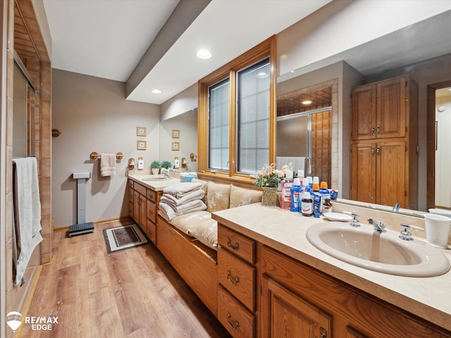 9705 Burning Tree Dr, Grand Blanc, MI 48439 - full bath with vanity, a stall shower, wood finished floors, and recessed lighting