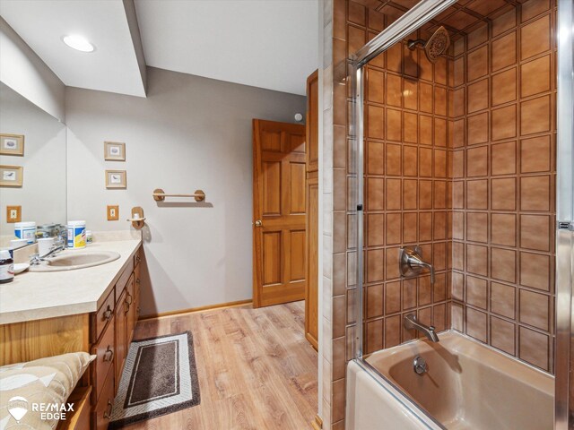 9705 Burning Tree Dr, Grand Blanc, MI 48439 - full bath featuring vanity, wood finished floors, and shower / tub combination