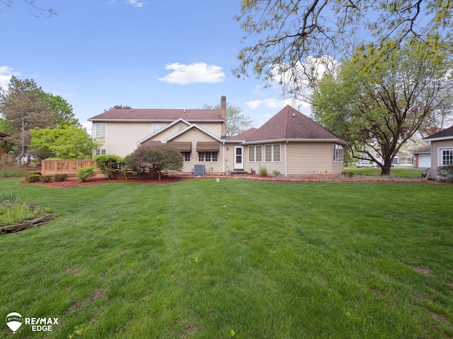 9705 Burning Tree Dr, Grand Blanc, MI 48439 - view of front facade featuring a chimney, a front lawn, and a deck