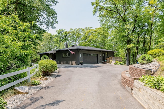 8680 Bennett St SE, Ada, MI 49301 - view of front of property featuring asphalt driveway and an attached garage