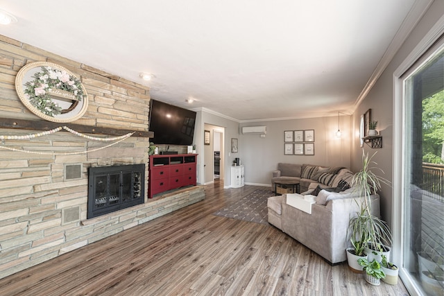 8680 Bennett St SE, Ada, MI 49301 - living area with a wall unit AC, wood finished floors, a fireplace, baseboards, and crown molding