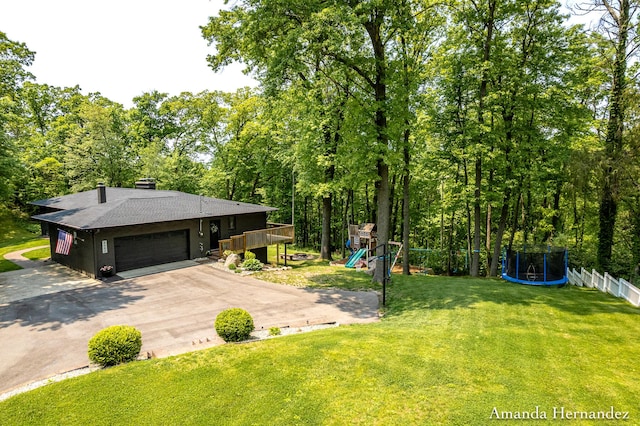 8680 Bennett St SE, Ada, MI 49301 - view of front facade with a playground, driveway, roof with shingles, and a garage