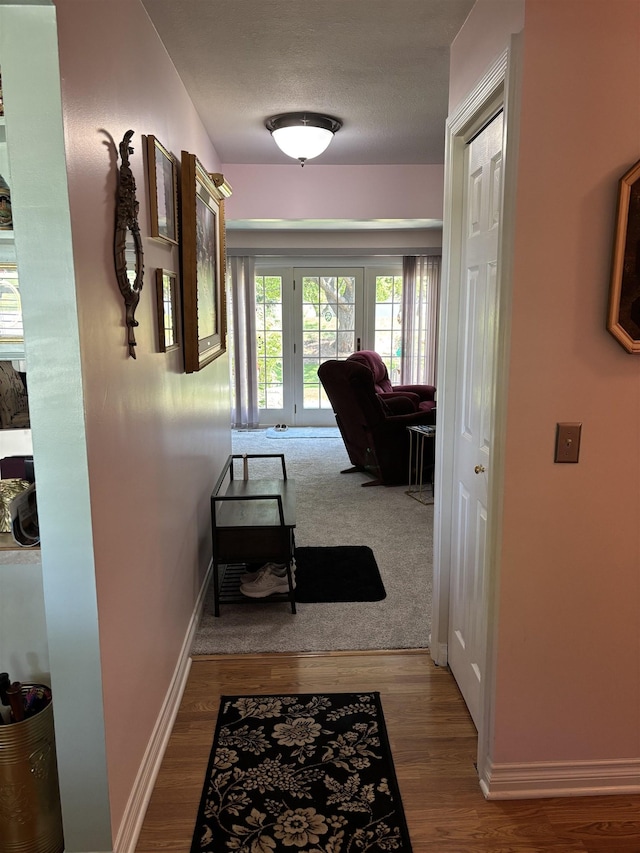 249 Churchgrove Rd, Frankenmuth, MI 48734 - corridor with baseboards, wood finished floors, and a textured ceiling