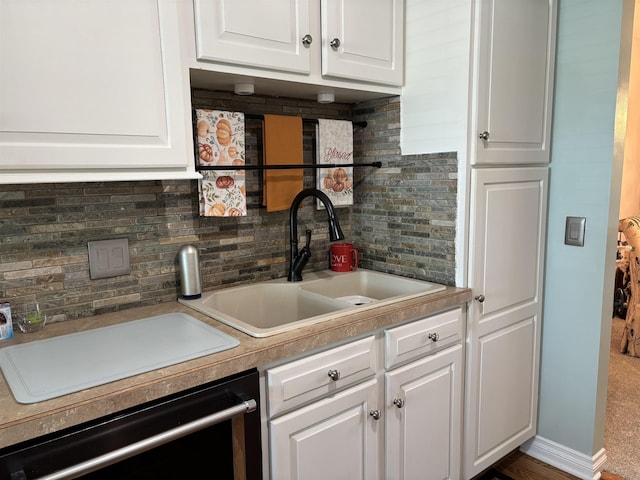 249 Churchgrove Rd, Frankenmuth, MI 48734 - kitchen featuring a sink, backsplash, white cabinets, and dishwashing machine