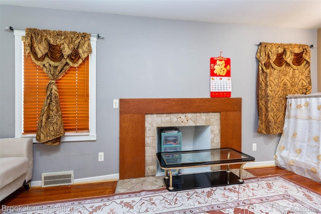20811 Doepfer Rd, Warren, MI 48091 - detailed view of wood finished floors, a tile fireplace, and baseboards