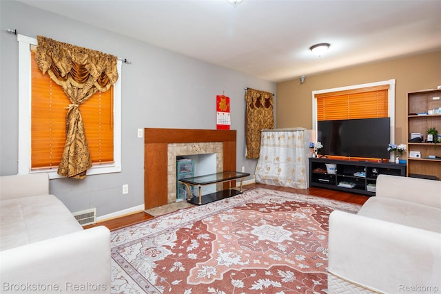 20811 Doepfer Rd, Warren, MI 48091 - living room featuring wood finished floors, baseboards, and a fireplace