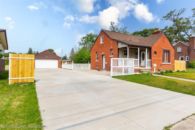 20811 Doepfer Rd, Warren, MI 48091 - view of front facade with covered porch, brick siding, a garage, and an outbuilding