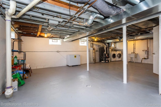 20811 Doepfer Rd, Warren, MI 48091 - below grade area featuring washing machine and clothes dryer, gas water heater, heating unit, and a sink
