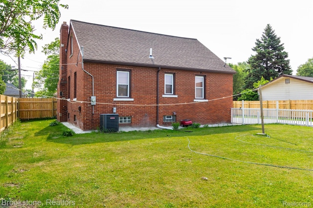20811 Doepfer Rd, Warren, MI 48091 - rear view of house featuring a shingled roof, central AC, brick siding, and a chimney