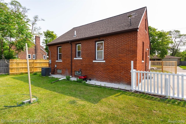 20811 Doepfer Rd, Warren, MI 48091 - back of property with roof with shingles, brick siding, and central air condition unit