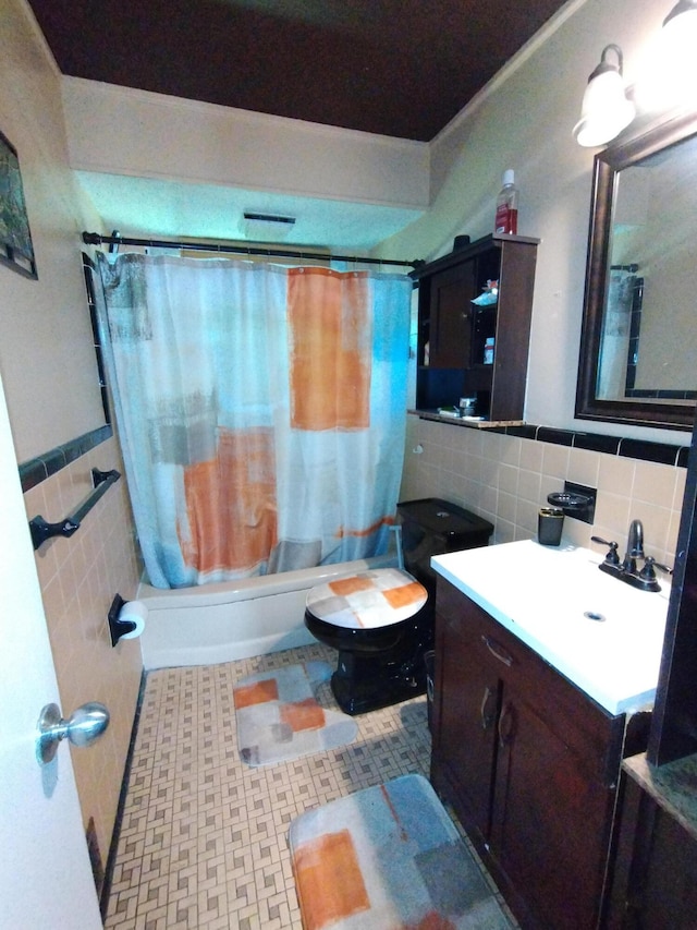8383 Dixie Ln, Dearborn Heights, MI 48127 - bathroom featuring tile walls, vanity, shower / tub combo, and a wainscoted wall